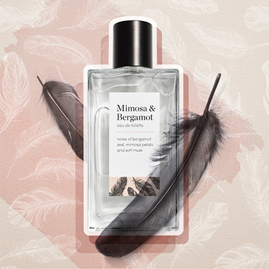 Photographic cut-out of fragrance bottle with black feathers
