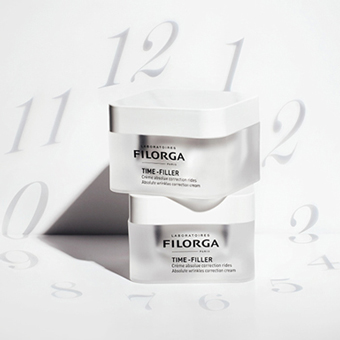 Two stacked beauty creams in front of projected clock numbers