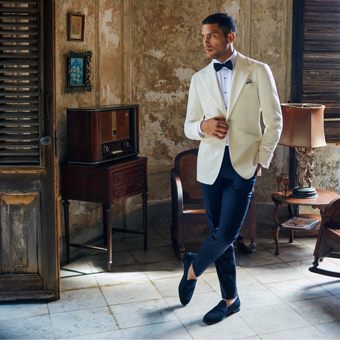 An elegant man wearing a white evening tux jacket in Havana house 