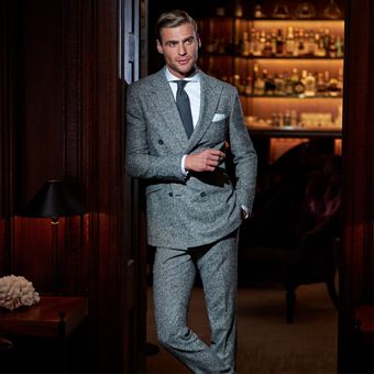 Man wearing double-breasted suit in the doorway of an exclusive bar