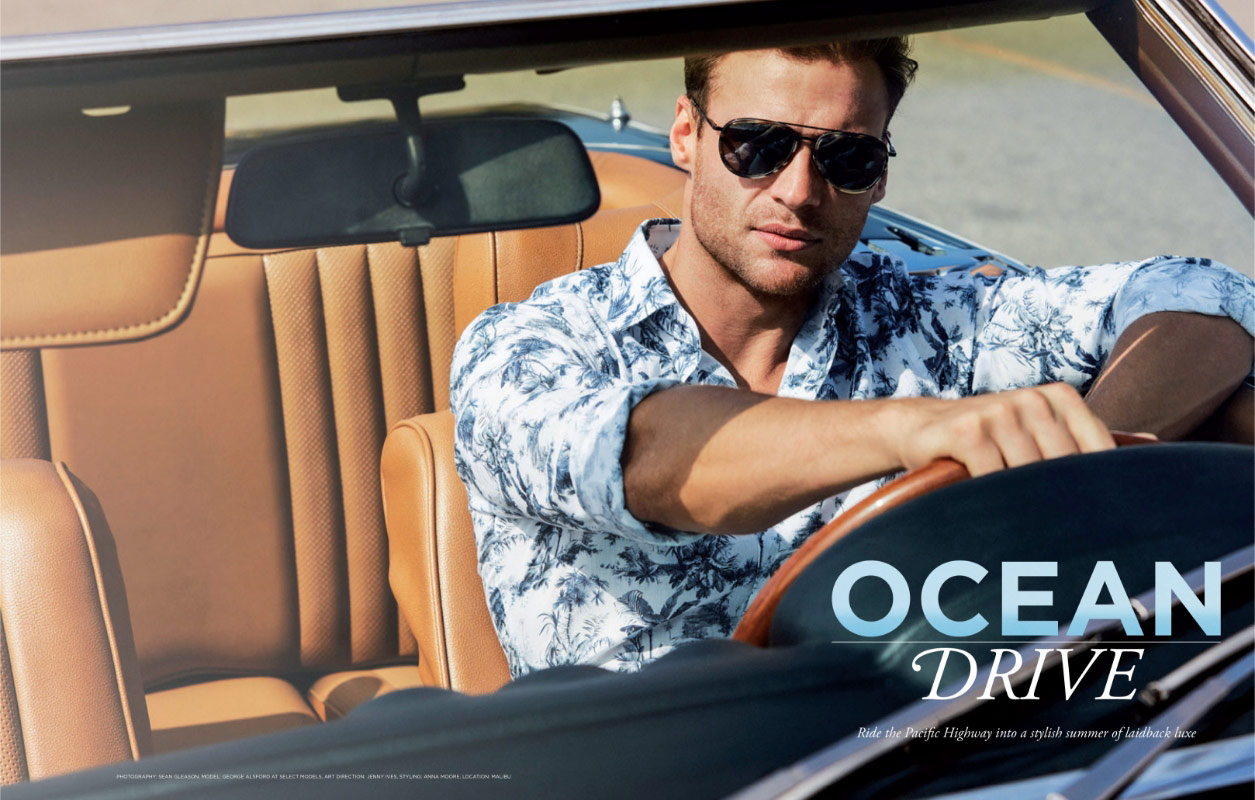 Man driving convertible car wearing palm print shirt
