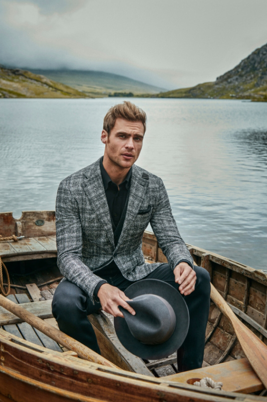 Various shots of a suited man sat in the Welsh mountains 